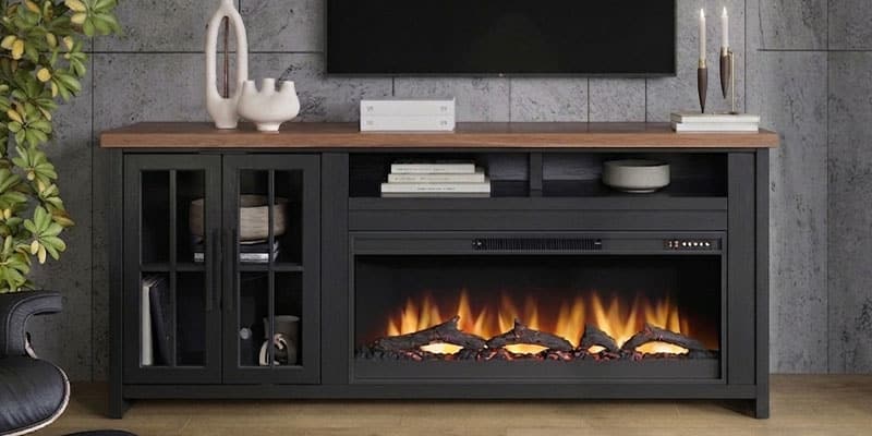 Electric fireplace media console styled with vases, candles, and a plant
