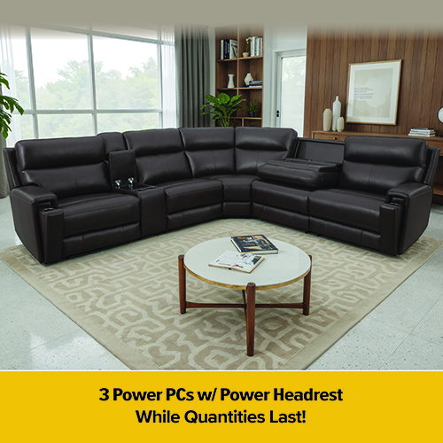 Promotional image for Darvin Clearance & Outlet Center showing a light gray sofa and loveseat set styled in a bright living room with gold-accented décor and a round coffee table on a plush rug. A clearance badge appears in the top left, and a red banner with a blue star at the bottom reads, “BUILT IN ★ AMERICA — Available in Grey.”