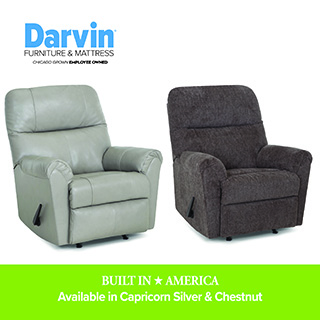 Two recliner chairs displayed side by side on a white background—one light green leather and one dark brown fabric. Darvin Furniture & Mattress branding appears above, with text reading “Built in America. Available in Capricorn Silver & Chestnut.”