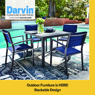 An advertisement for Darvin Furniture & Mattress featuring an outdoor dining set by a swimming pool. The set includes a square dark-framed table and four matching chairs with blue mesh seating. The furniture is placed on a patterned blue outdoor rug. A yellow banner at the bottom states: Outdoor Furniture is HERE! Stackable Design.