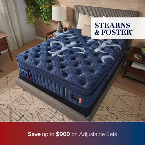 A promotional advertisement for Stearns & Foster mattresses featuring a blue quilted mattress in a warm, wood-paneled bedroom. The bottom banner reads 'Save up to $900 on Adjustable Sets'.
