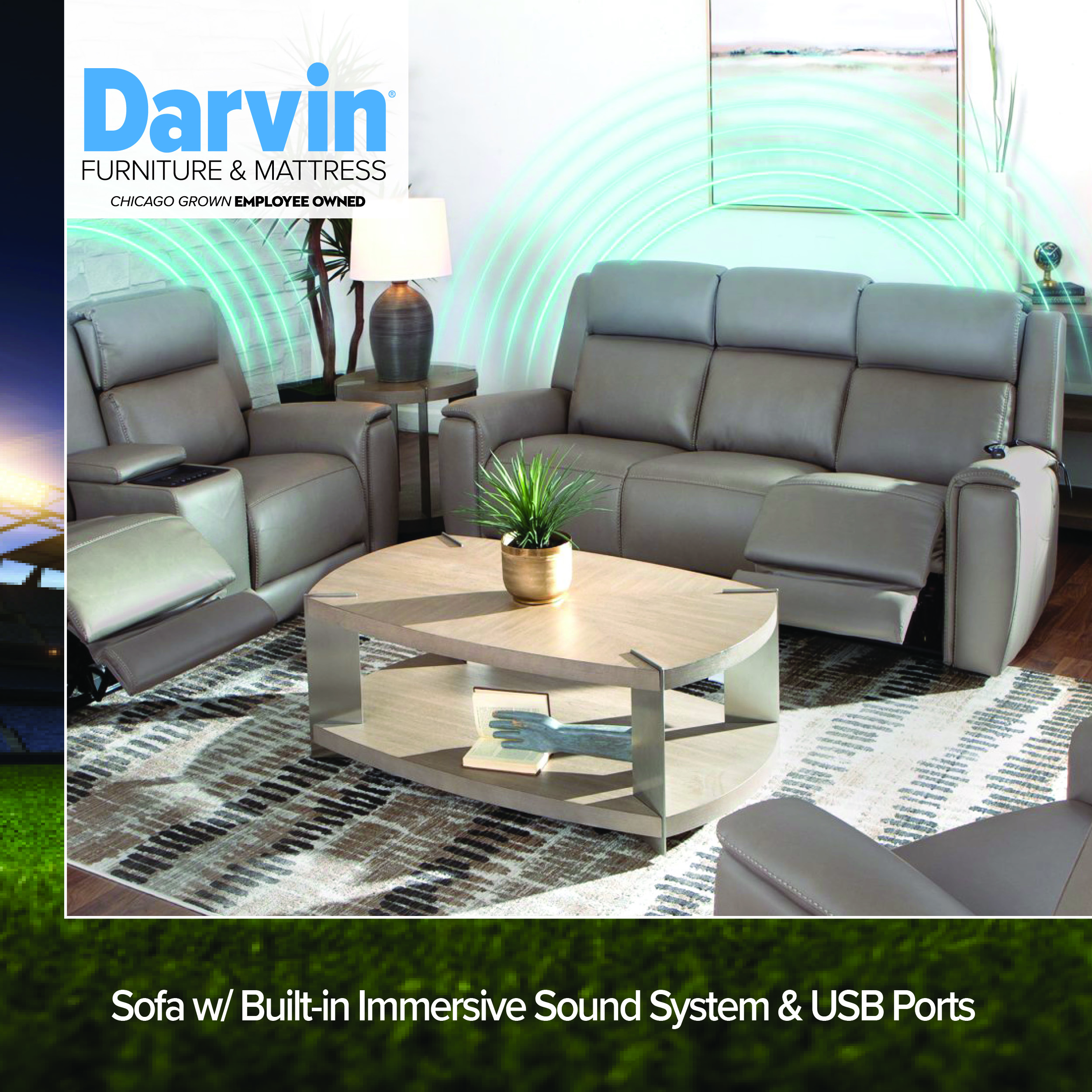 Darvin Furniture & Mattress logo, Chicago Grown Employee Owned, above a gray leather reclining living room set including a loveseat, sofa, and armchair with glowing sound wave graphics, arranged around an oval wood and metal coffee table with a potted plant, on a patterned area rug, with a stadium image accent on the left edge. Text reads Sofa w/ Built-in Immersive Sound System & USB Ports.