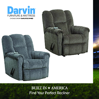 Darvin Furniture & Mattress logo above two reclining chairs in blue-gray fabric, with a stadium image accent on the right edge. Text reads BUILT IN AMERICA, Find Your Perfect Recliner.