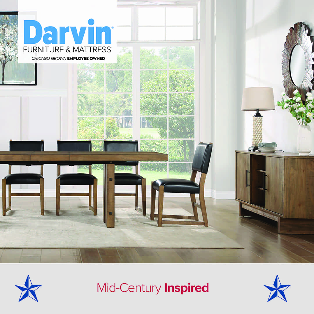 Mid-century inspired dining room featuring a wooden table with black cushioned chairs and a matching sideboard. The space has large windows, light walls, and minimal décor. Text reads: “Darvin Furniture & Mattress – Chicago Grown Employee Owned – Mid-Century Inspired,” with blue stars on each side.