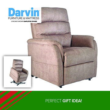A Darvin Furniture & Mattress promotional image featuring a taupe upholstered recliner chair. A small inset photo shows the same chair in a raised lift position. At the bottom, a green banner reads: PERFECT GIFT IDEA!