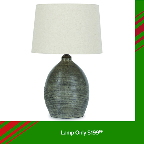A product image of a table lamp with a rounded, textured ceramic base in a dark gray tone and a simple off-white fabric lampshade. The lamp is displayed against a white background. A green banner at the bottom reads: Lamp Only $199.99.
