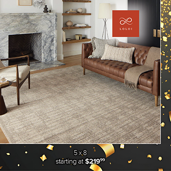 Promotional image of a patterned area rug displayed in a living room with two lavender armchairs and a white sofa. The Feizy Rugs logo appears at the top. Text at the bottom reads, 5 x 8 starting at $999.99.'