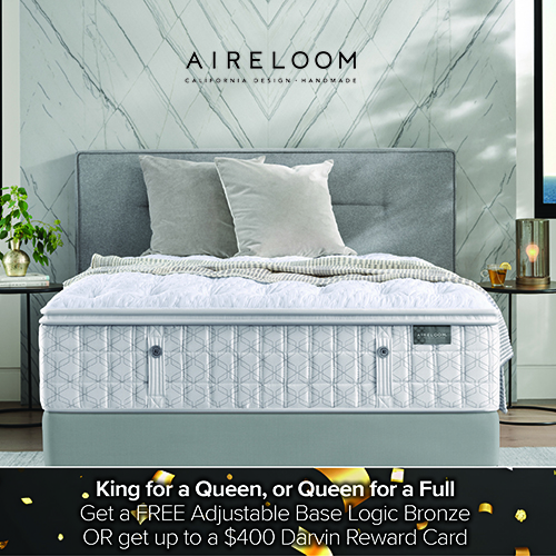 Promotional image of an Aireloom mattress on a modern upholstered bed with layered white and gray bedding. Text above the bed reads Aireloom – California Design, Handmade. Text at the bottom reads, King for a Queen, or Queen for a Full. Get a FREE Adjustable Base Logic Bronze OR get up to a $400 Darvin Reward Card.