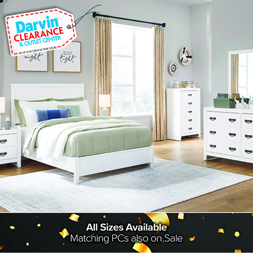 Promotional image of a rustic bedroom set with a wooden twin or full bed dressed in red, white, and blue plaid bedding, along with matching dresser and nightstand. A Darvin Clearance Outlet Center badge appears in the top left. Text at the bottom reads, Twin or Full Available. Matching PCs also on Sale.
