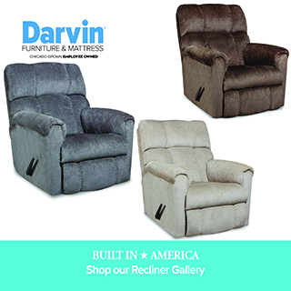 A promotional advertisement for Darvin Furniture & Mattress featuring the Built in America recliner collection. The graphic displays three plush, overstuffed fabric recliners with manual lever handles, arranged diagonally across a white background. On the left is a slate blue recliner, in the upper right is a dark chocolate brown recliner, and in the lower right is a light taupe recliner. The upper left corner displays the blue and black Darvin Furniture & Mattress logo with the text 'Chicago Grown Employee Owned'. A solid teal banner running along the bottom reads 'BUILT IN AMERICA' in white serif text, followed by 'Shop our Recliner Gallery' in a clean white sans-serif font.