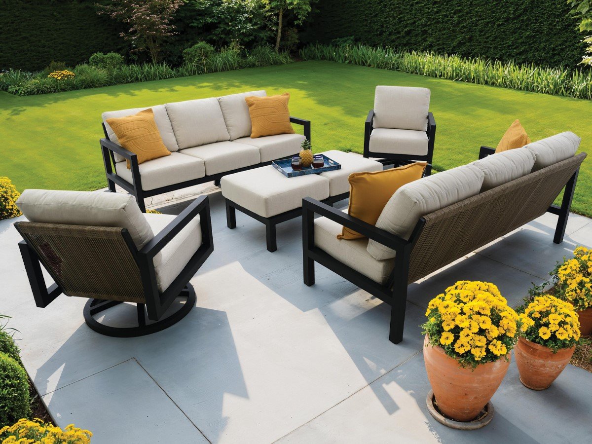 Outdoor patio conversation set with sofa, chairs, and table