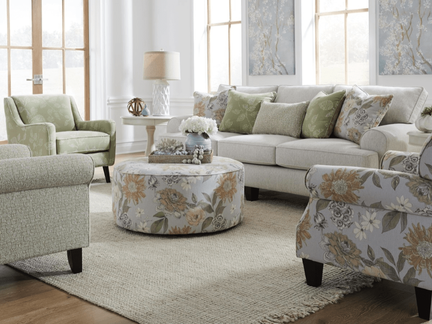Living room with sofa, loveseat, and floral accent chairs