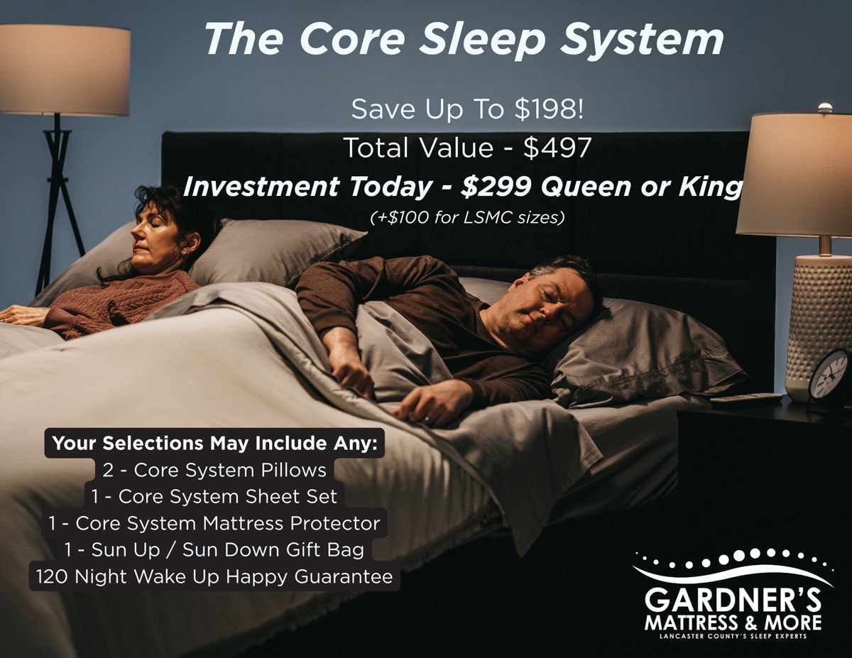 Gardner’s Mattress & More promotional graphic for The Core Sleep System. Two people lie in bed with gray bedding between bedside lamps. Text reads: The Core Sleep System. Save Up To $198. Total Value $497. Investment Today $299 Queen or King, plus $100 for LSMC sizes. Your selections may include: 2 Core System Pillows, 1 Core System Sheet Set, 1 Core System Mattress Protector, 1 Sun Up/Sun Down Gift Bag, and a 120 Night Wake Up Happy Guarantee. Gardner’s Mattress & More logo appears in the lower right corner.