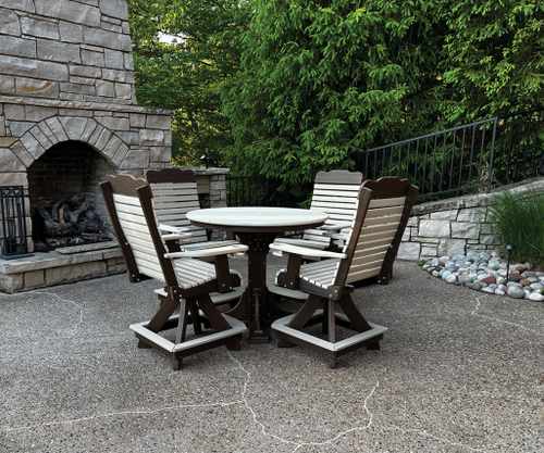 Ponvue outdoor seating set with four swivel chairs around a round table beside a stone fireplace and lush greenery.