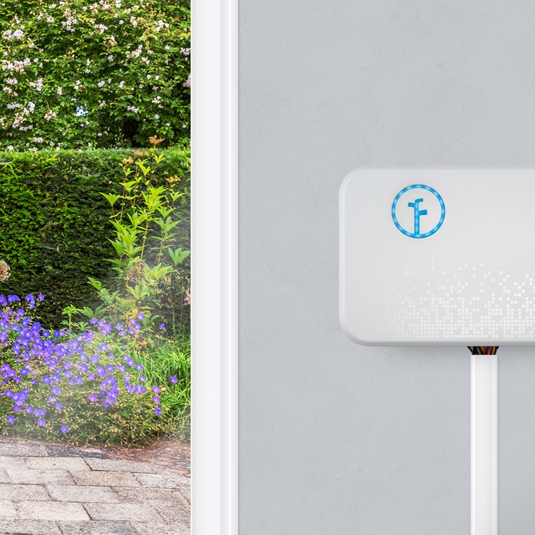 Rachio irrigation meter mounted the exterior wall of a house