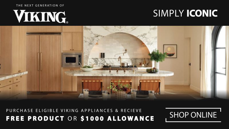Wide promotional banner for Viking appliances showing a luxurious modern kitchen with light wood cabinetry, a marble island, built-in Viking appliances, and an arched stone backsplash. Text at the top reads ‘The Next Generation of Viking’ and ‘Simply Iconic.’ Text at the bottom reads ‘Purchase Eligible Viking Appliances & Receive Free Product or $1000 Allowance,’ alongside a ‘Shop Online’ button on a black background.