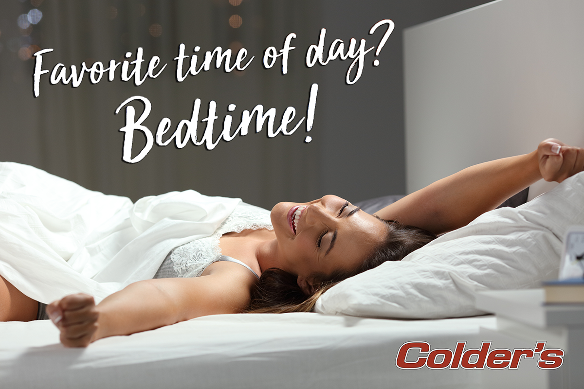 A woman stretches, thus expressing that her favorite time of day is bedtime