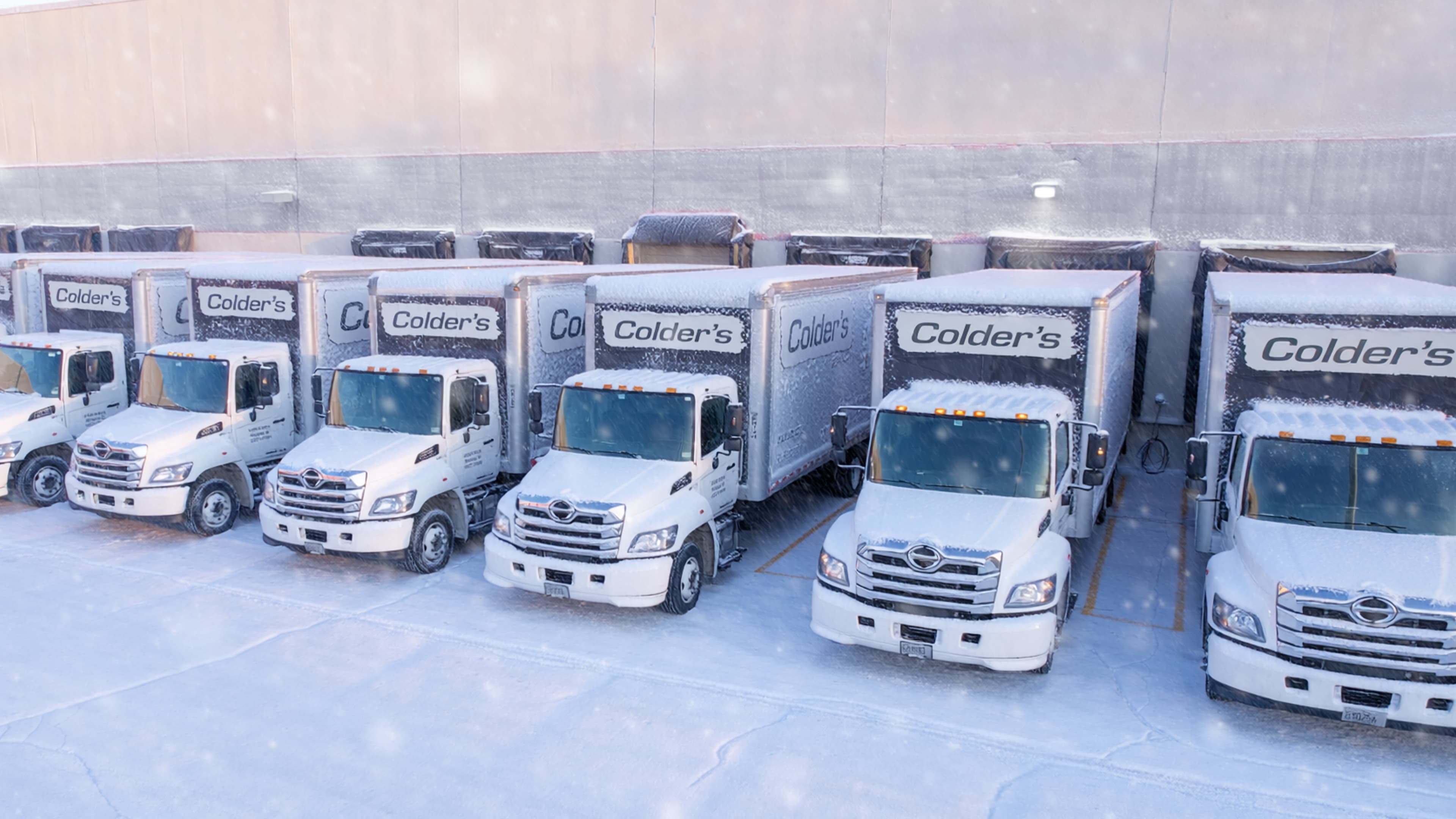 delivery trucks in warehouse parking lot