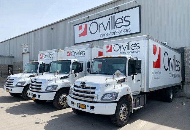 View of Orville's Appliance delivery trucks