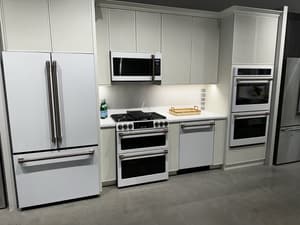 Café kitchen with matte white appliances and brass hardware