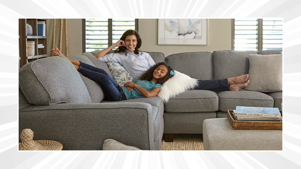 Mom and daughter relaxing on sectional in living room
