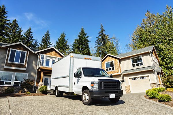 A white moving truck in a driveway 