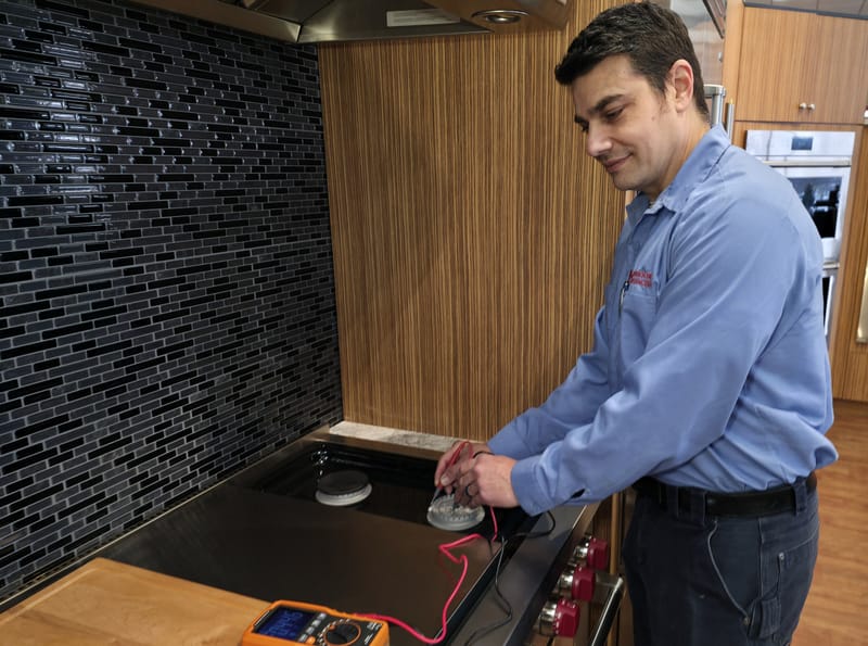 Morehouse Appliances factory-certified technician performing appliance service.