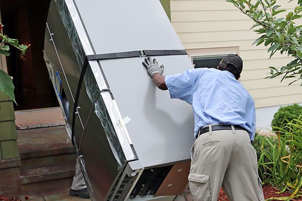 Two Men Hauling Away a Refrigerator