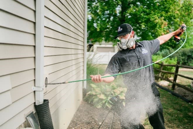 Professional technician performing dryer vent cleaning service on a Maine home ahead of fall's heavier laundry season
