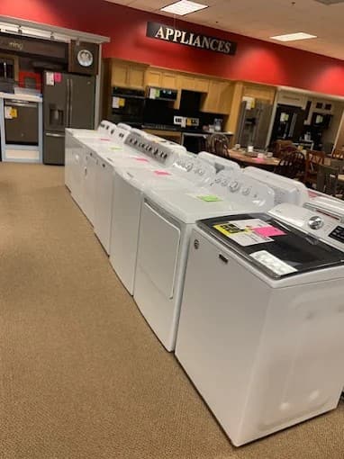 Fortin's laundry appliance showroom floor — washers and dryers on display in Winslow Maine