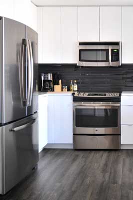 A kitchen with a refrigerator.