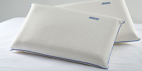 Two pillows on top of a bed