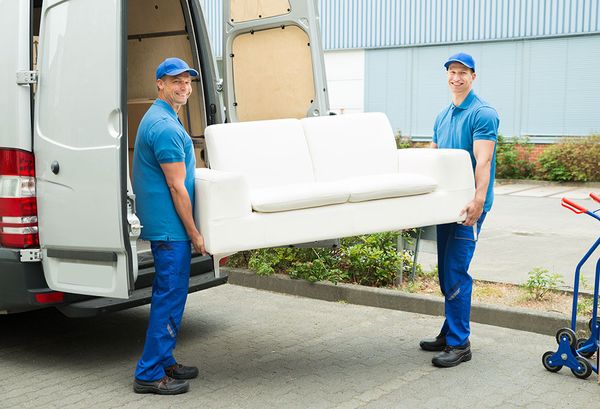 Delivery staff carrying a sofa
