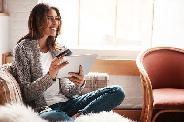 Woman holding a tablet and credit card
