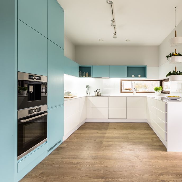 Kitchen with colorful blue cabinets and white walls